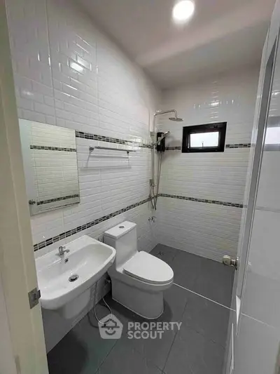 Modern bathroom with sleek white tiles and contemporary fixtures