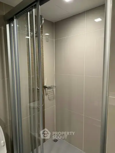 Modern bathroom with sleek shower enclosure and contemporary design.