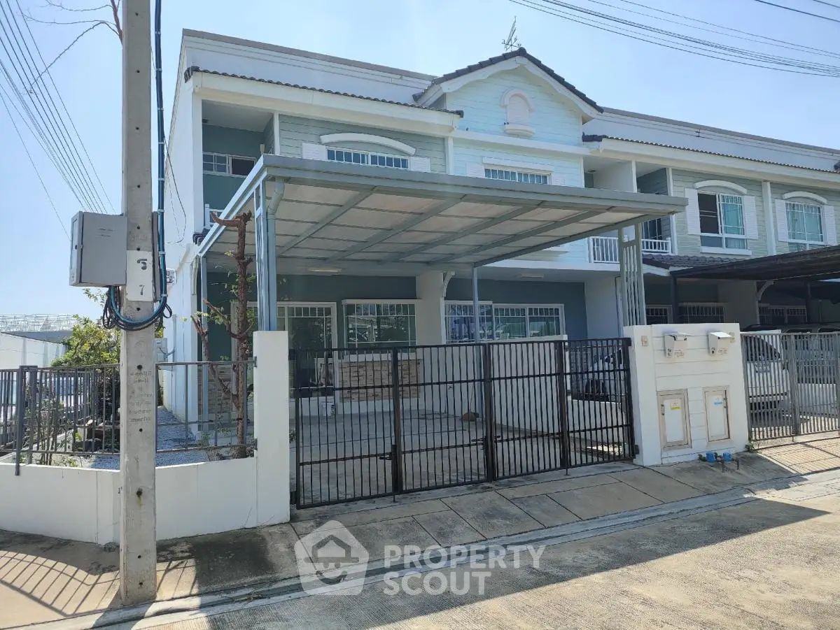 Charming two-story townhouse with covered parking and gated entrance in a serene neighborhood.
