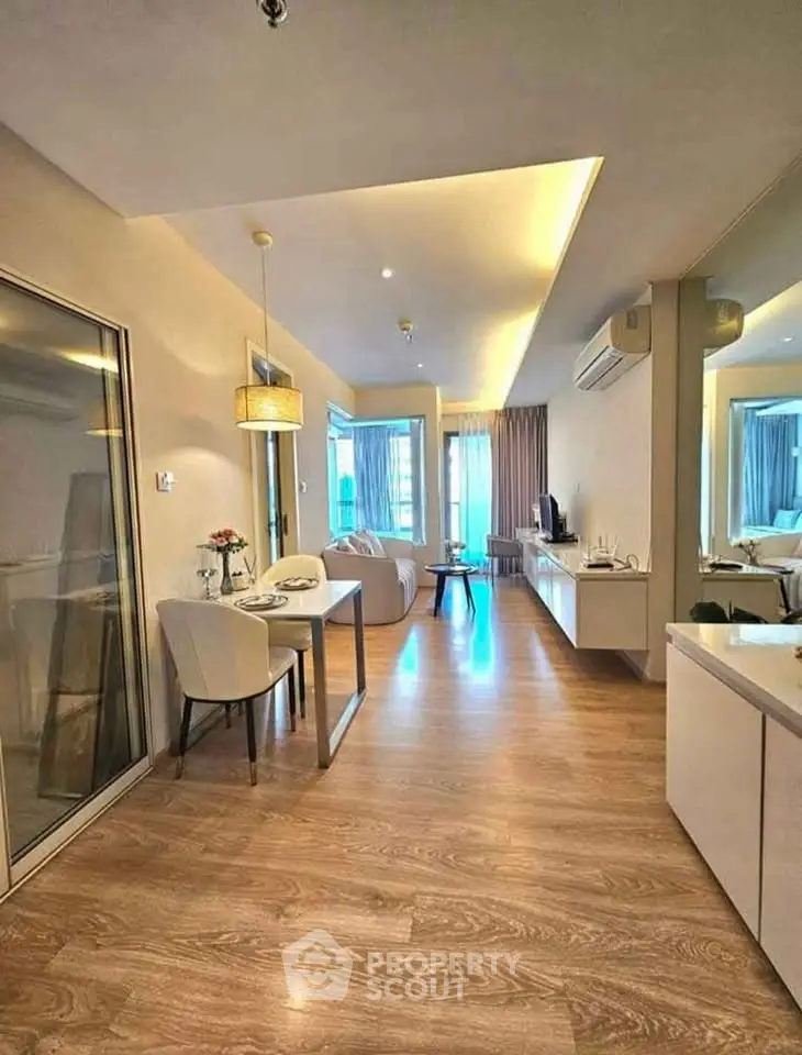 Modern open-plan living room with stylish dining area and wooden flooring