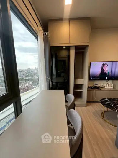 Modern living room with city view, stylish furniture, and large windows for natural light.