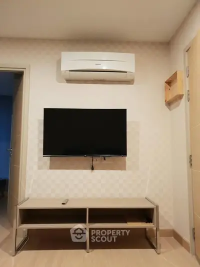 Modern living room with wall-mounted TV and air conditioning unit