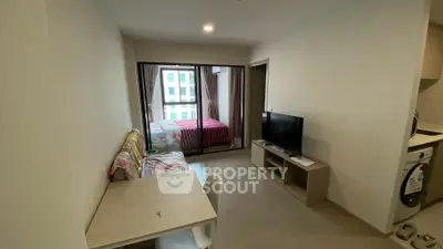 Modern apartment interior with cozy living area and bedroom view, featuring stylish furniture and natural light.