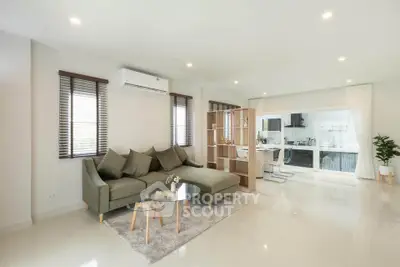 Modern open-plan living room with stylish furniture and natural light