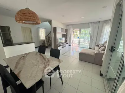 Spacious open-plan living and dining area with modern furnishings and natural light.
