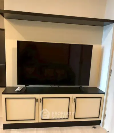 Modern living room with sleek TV stand and mounted flat-screen TV, perfect for entertainment.