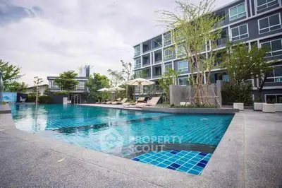 Luxurious modern apartment complex with stunning pool and lush greenery