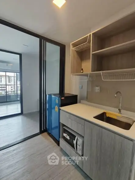 Modern kitchen with open layout and sleek appliances in a stylish apartment.