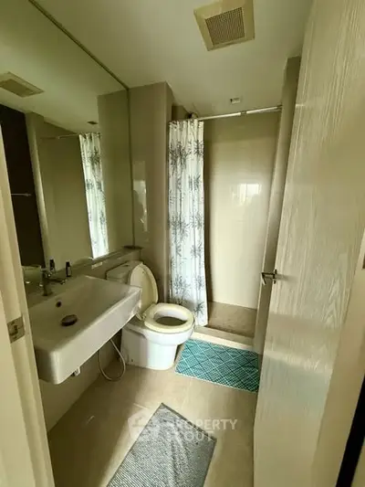 Modern bathroom with shower and sleek fixtures in a contemporary apartment.