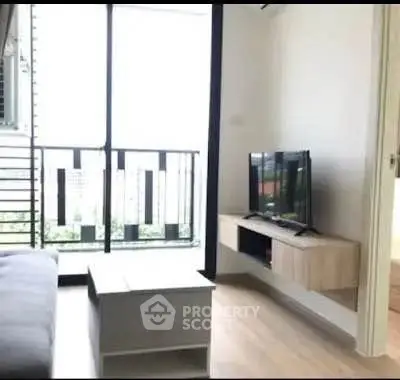 Modern living room with balcony and sleek TV setup