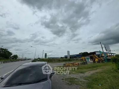 Expansive roadside view with construction equipment and overcast sky