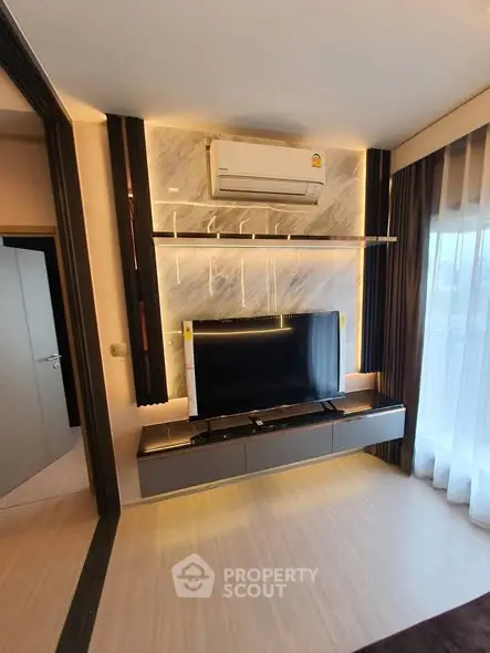 Modern living room with sleek TV setup and ambient lighting