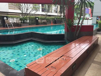 Luxurious outdoor pool area with modern design and lush greenery, perfect for relaxation and leisure.