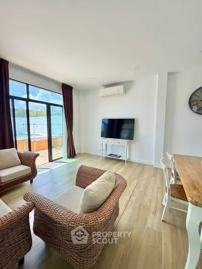 Bright living room with modern furniture and large window offering natural light.