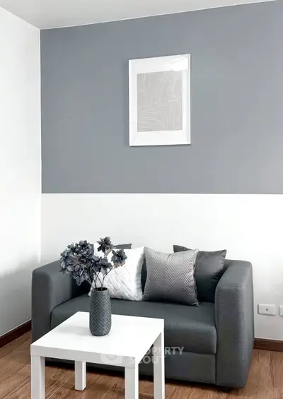 Modern living room with stylish gray sofa and decorative pillows