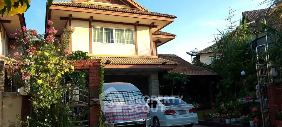 Charming suburban house with lush garden and driveway in a peaceful neighborhood.