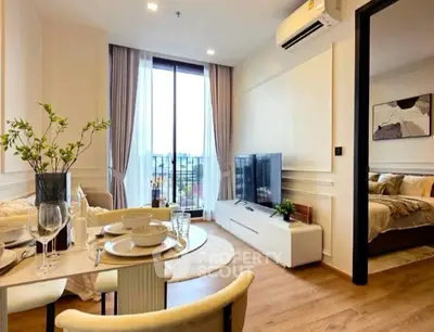 Modern living room with dining area and bedroom view, featuring elegant decor and natural light.