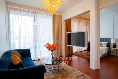 Luxurious living room with elegant decor and city view, featuring plush sofa and modern chandelier.