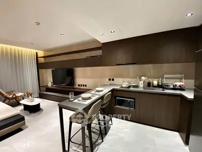 Modern open-layout kitchen with sleek cabinetry and integrated appliances in a stylish apartment.