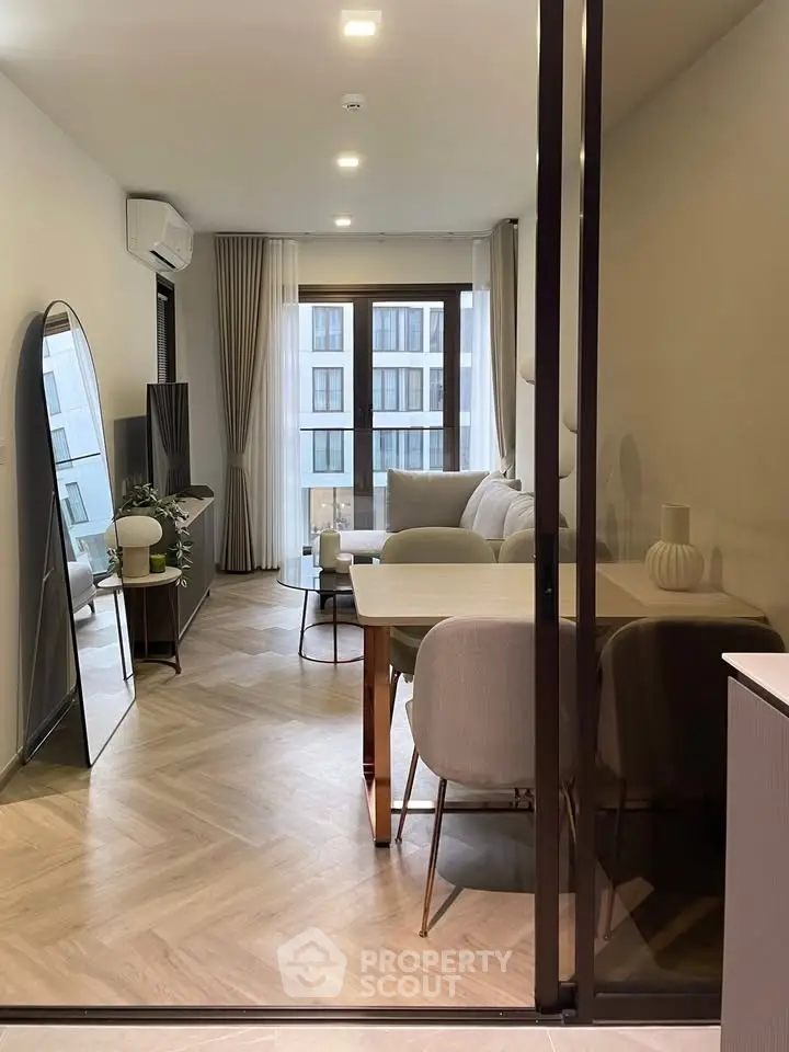 Modern living room with elegant decor and large windows in a stylish apartment.