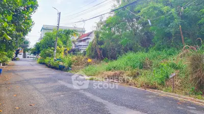 Charming residential street with lush greenery and cozy homes, perfect for serene living.