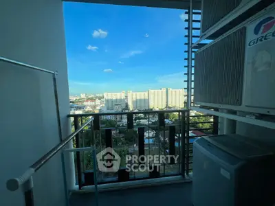 High-rise balcony with cityscape view and air conditioning units.