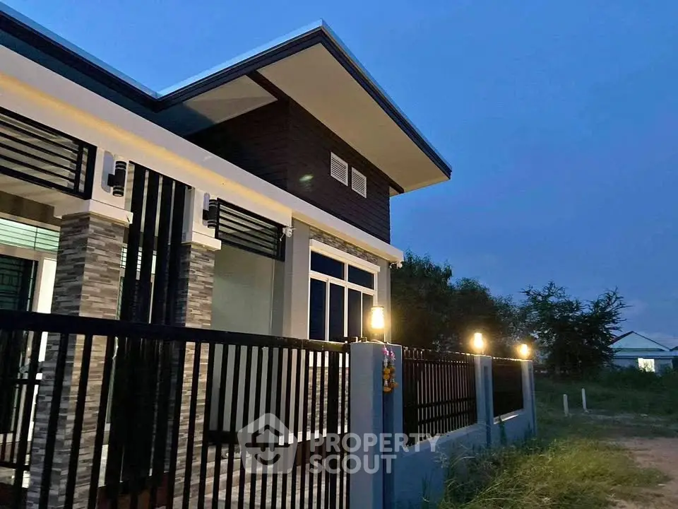Modern single-story house with sleek design and ambient lighting at dusk.