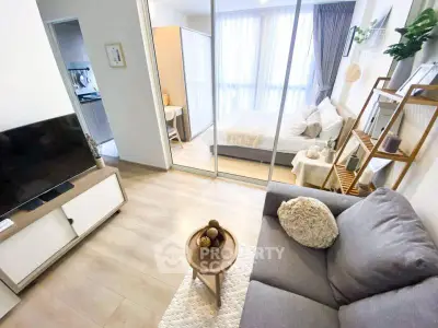 Modern open-plan living room with cozy bedroom and stylish decor