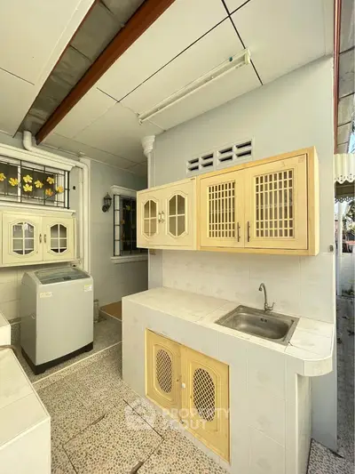 Charming outdoor kitchen with washing machine and vintage cabinets