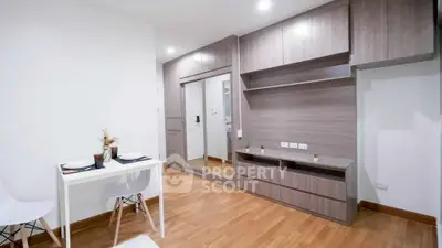 Modern minimalist living space with wooden flooring and sleek cabinetry