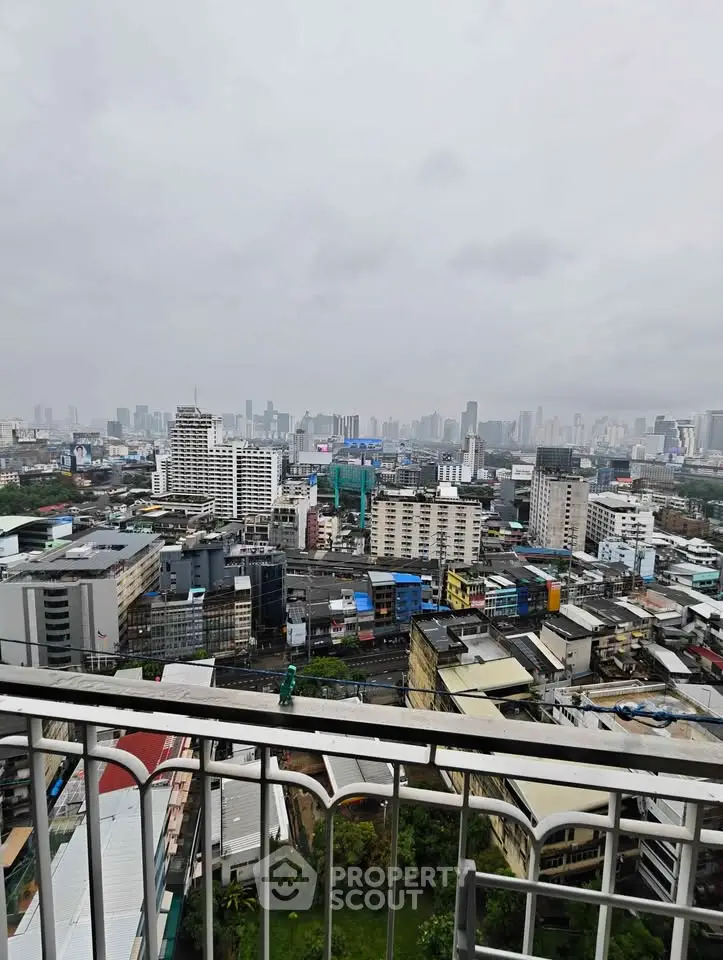 Stunning cityscape view from a high-rise balcony showcasing urban skyline and vibrant city life.