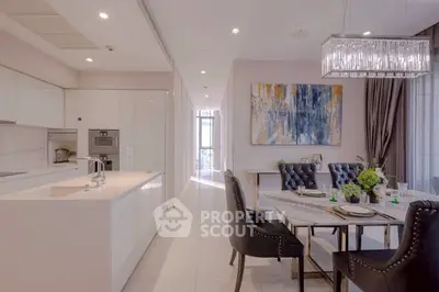 Luxurious modern kitchen and dining area with elegant decor and ample natural light.