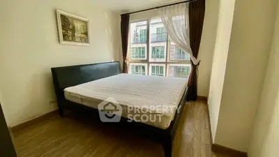 Spacious bedroom with large window and elegant decor in modern apartment