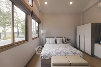 Spacious bedroom with large windows and modern decor