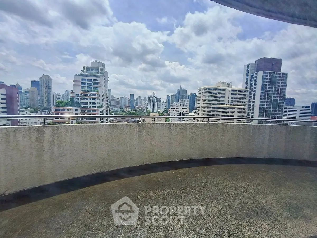 Stunning cityscape view from a spacious balcony in a high-rise building.