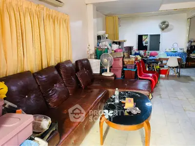 Spacious living room with leather sofa and eclectic decor