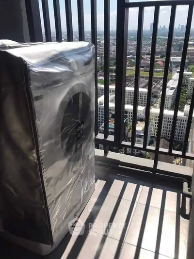 High-rise balcony with city view and covered washing machine