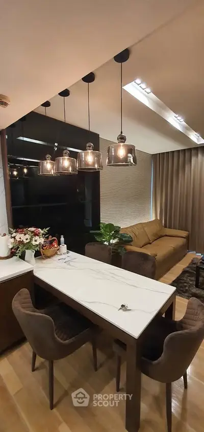 Modern living room with elegant lighting and stylish furniture, perfect for cozy gatherings.