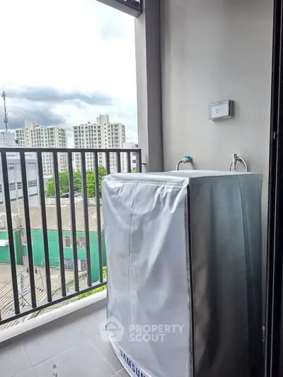 Modern balcony with washing machine and city view, perfect for urban living convenience.
