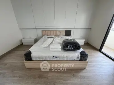 Modern bedroom with minimalist design and large bed in a bright apartment.
