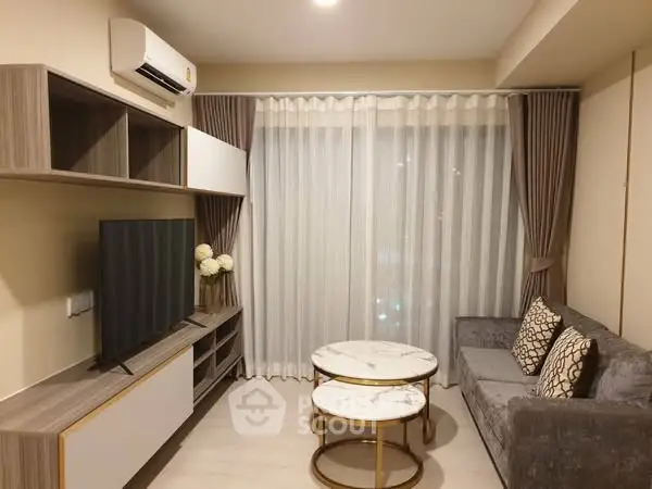Modern living room with stylish furniture and large window for natural light