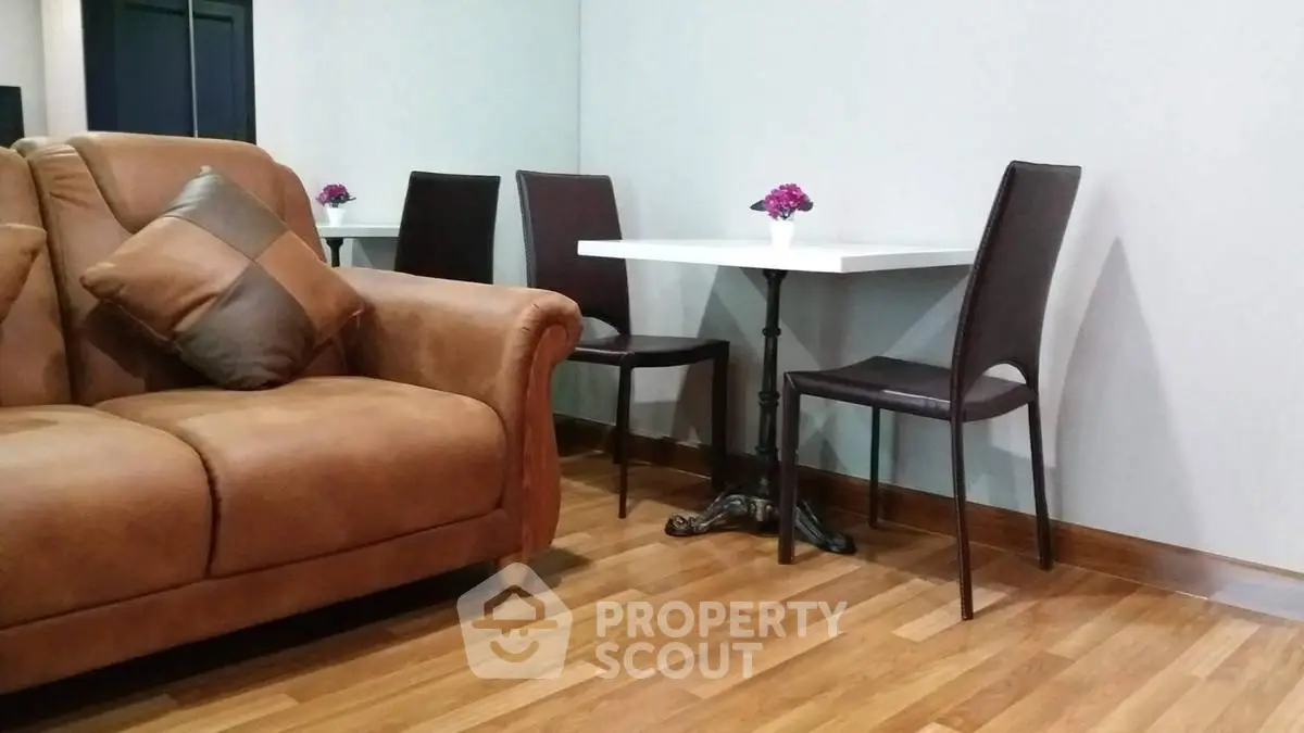 Cozy living room with elegant leather sofa and chic dining area