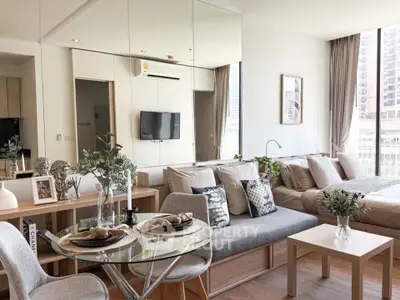 Modern open-plan living room with dining area and cozy bedroom in stylish apartment