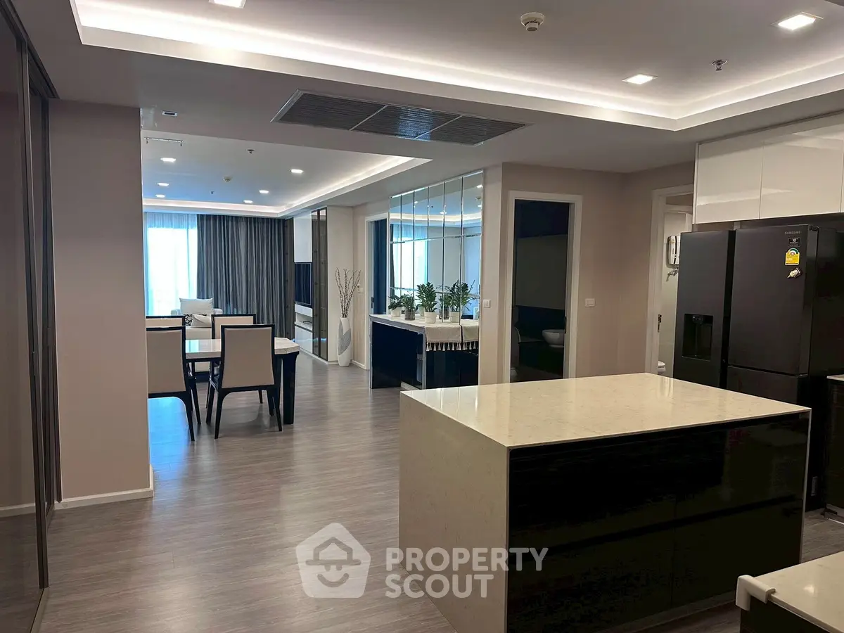 Spacious modern kitchen and dining area with sleek design and ample natural light.
