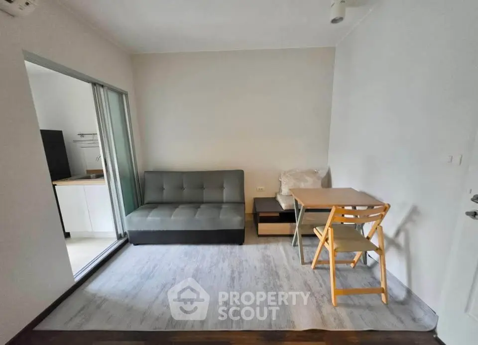 Cozy living room with modern sofa and dining area in compact apartment