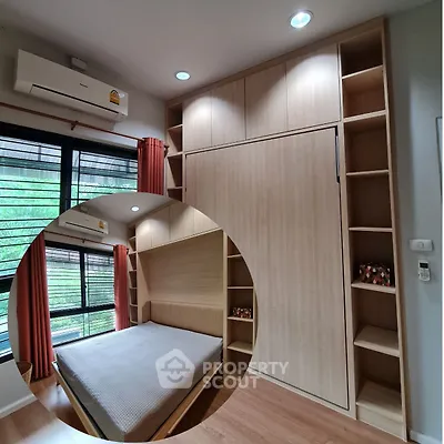 Modern bedroom with built-in storage and large window for natural light
