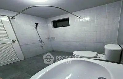 Spacious modern bathroom with sleek fixtures and minimalist design.