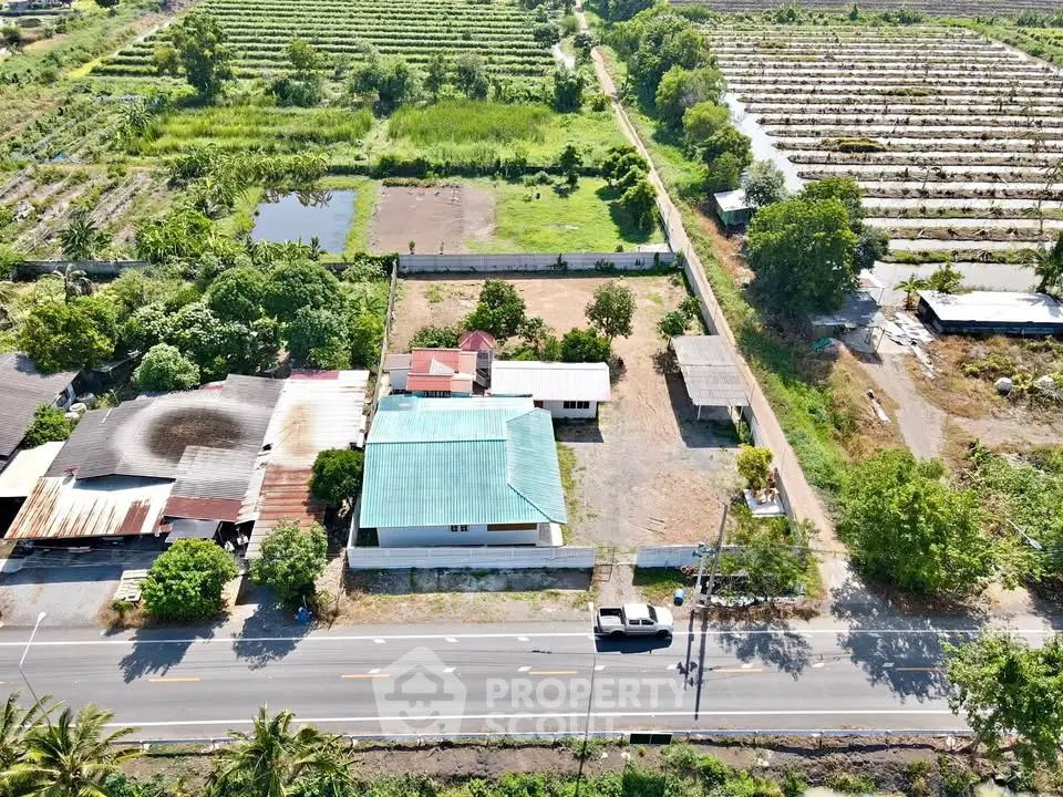 Aerial view of rural property with house, garden, and surrounding farmland.