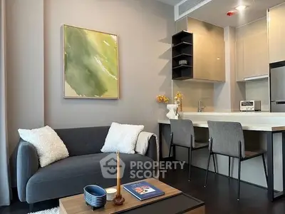 Modern living room with cozy sofa and stylish kitchen in open layout apartment.