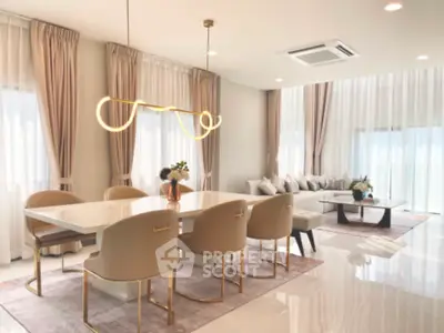 Luxurious open living and dining area with elegant decor and modern lighting